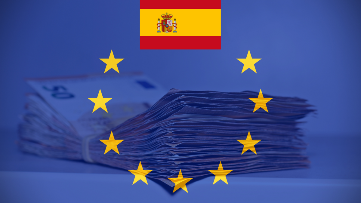 Pile of fifty euros on the table with the European Flag and the Spanish Flag