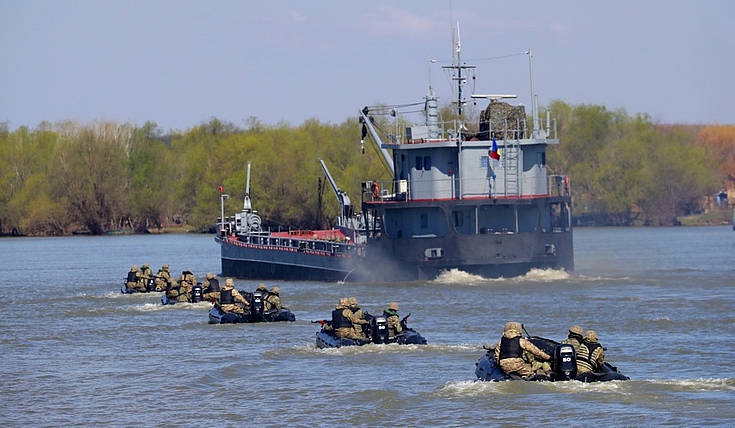 Romanian Navy light crafts escort a dredger ship during NATO exercise Sea Shield 2023 in the Danube Delta near Mahmudia harbor